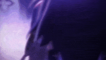 a blurry picture of a person 's face in a purple light