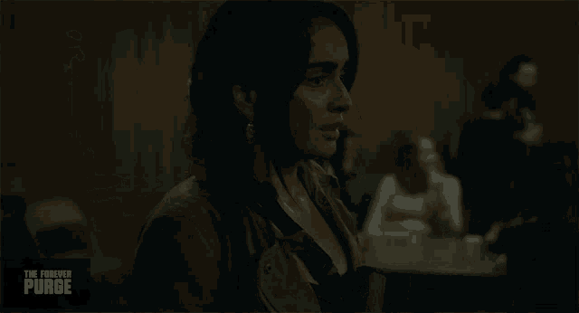 a woman in a dark room with the words the forever purge on the bottom right
