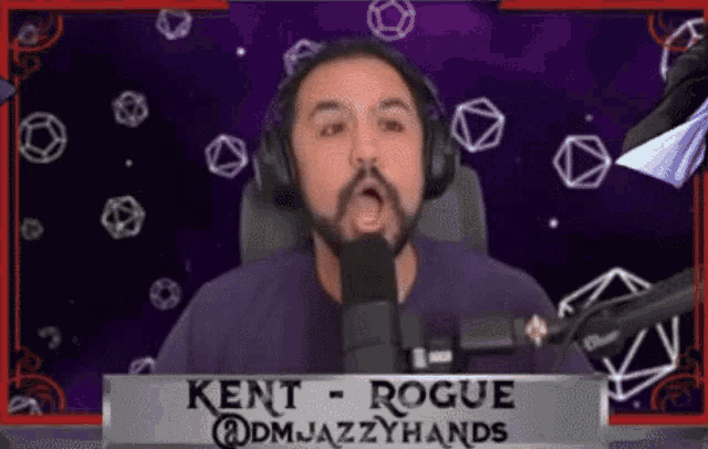 a man wearing headphones and a name tag that says kent rogue on it