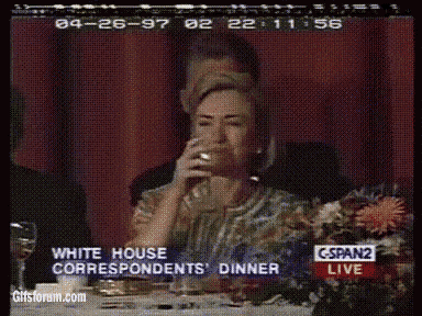 a woman sitting at a table drinking from a glass with the words white house correspondents dinner in the corner