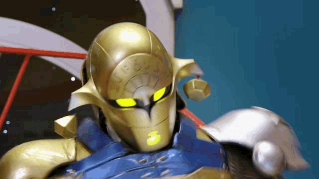 a close up of a gold robot with a clock on its head