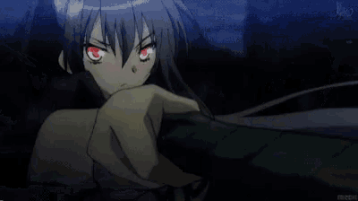 a close up of a girl with red eyes in a dark room .