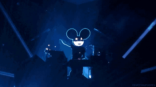 a mickey mouse with glowing eyes and ears is on a stage