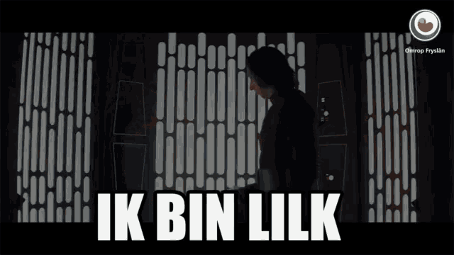a man is standing in a dark room with the words ik bin lik written on the bottom