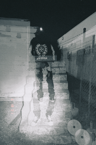 a black and white photo of a person with a chrome hearts shirt on