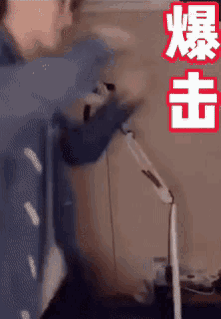 a man is standing next to a lamp with chinese writing on it