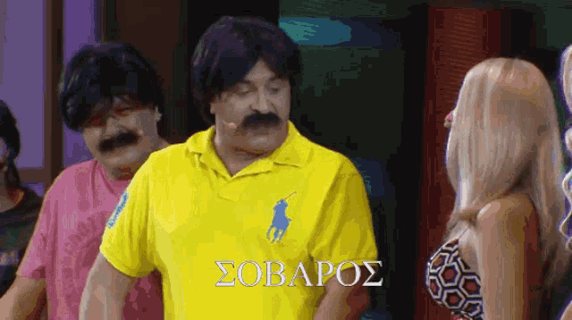 a man wearing a yellow polo shirt with a blue horse on the front