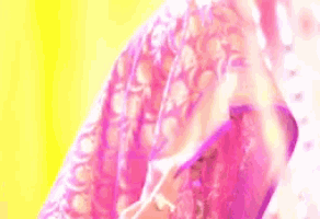 a woman with pink hair is wearing a pink and white dress