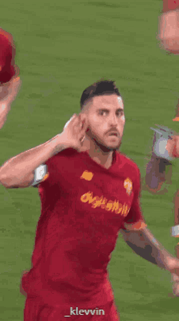 a soccer player wearing a red shirt with digitalbit on it