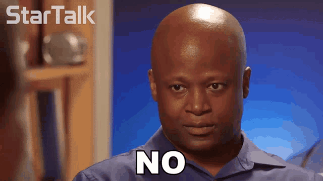 a man in a blue shirt says no in front of a startalk logo