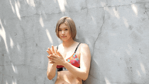 a woman wearing a calvin klein bra stands in front of a wall
