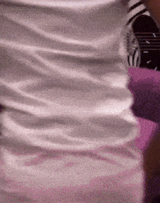a person wearing a white shirt with a black and white logo on it