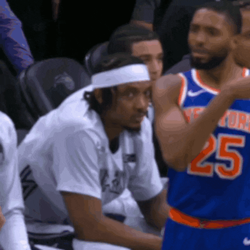 a man wearing a headband and a jersey with the number 25