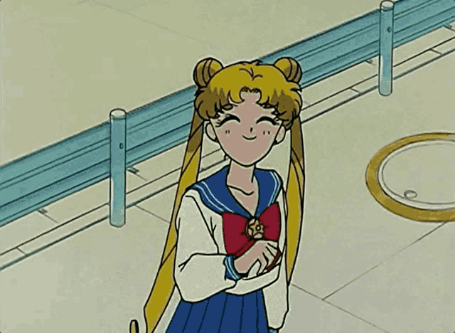 a girl in a sailor suit with a red bow is waving her hand