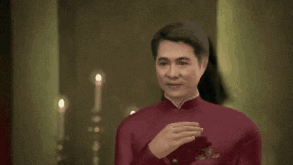 a man in a red suit is standing in front of a woman