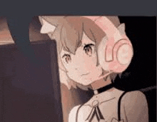 a girl wearing headphones with a microphone on her head .