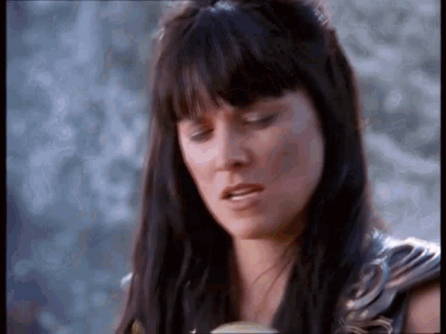 a close up of a woman with dark hair making a funny face .