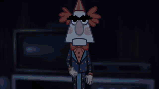 a hand is holding a clown 's head in a dark room