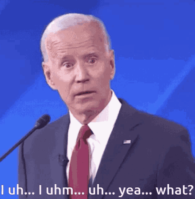 a man in a suit and tie is speaking into a microphone and the words i uhm uh yea what are below him