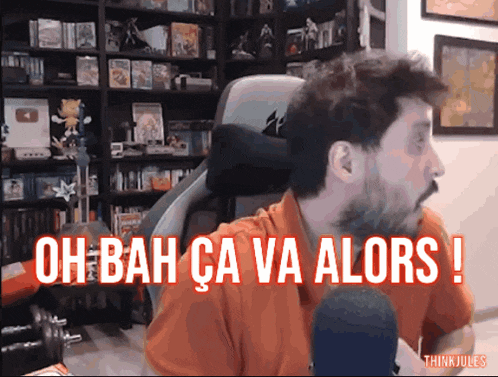 a man sitting in front of a microphone with the words oh bah ca va alors written below him