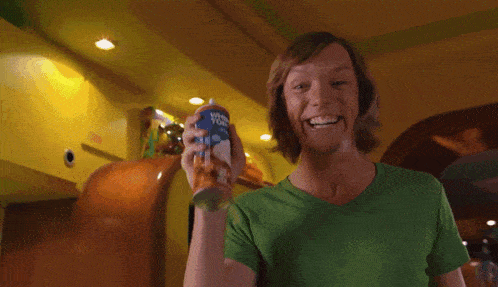 a scooby doo dog is being fed a can of dog food