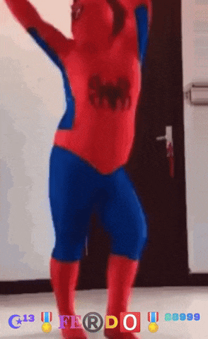 a person in a spider man costume is dancing in front of a door