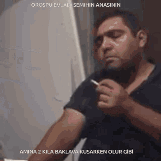 a man in a black shirt is smoking a cigarette with the words amina 2 kila baklava kusarken olur gibi below him