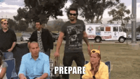 a group of people are standing in a park with the word prepare written on the ground