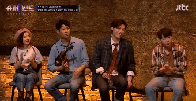 a group of people sitting in front of a brick wall with jtbc written on the bottom of the screen