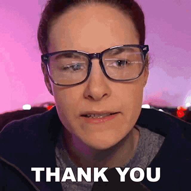 a woman wearing glasses says " thank you " in front of her face