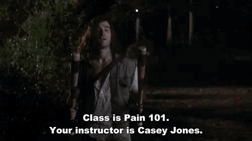 a man with long hair is holding a guitar and says " class is pain 101 your instructor is casey jones " .