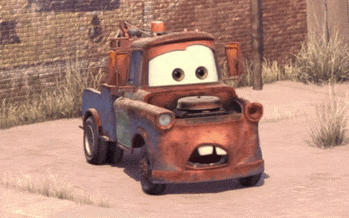 a cartoon tow truck with its mouth open and a brick wall behind it