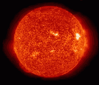 a close up of a bright red sun with a black background