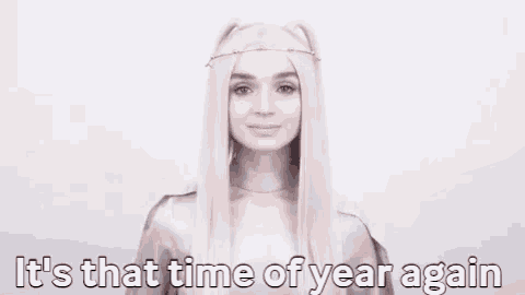 a woman with long blonde hair is smiling and saying it 's that time of year again