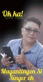 a man wearing glasses is holding a cellphone and giving a thumbs up