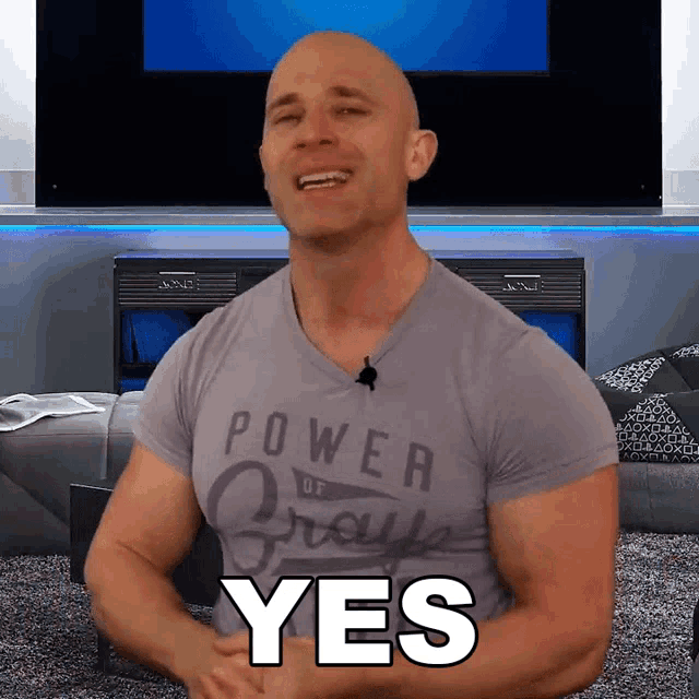 a man wearing a grey shirt that says power of grays on it