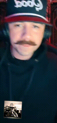 a man with a mustache wears a hat that says good on it