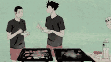 a group of people are standing around a table with a grill .