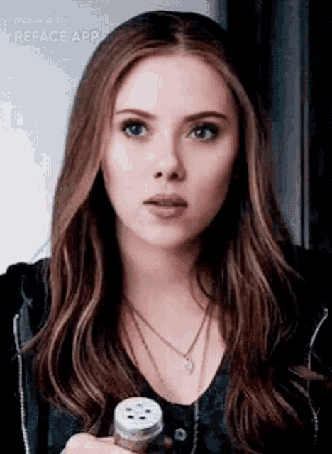 scarlett johansson is wearing a necklace and holding a salt shaker in her hand .