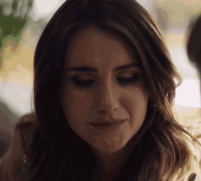 a close up of a woman 's face with a slight smile on her face