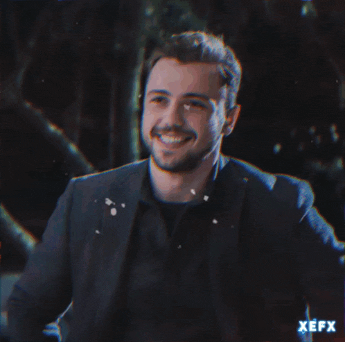 a man in a suit is smiling with a fire coming out of his chest and the word pasav is visible