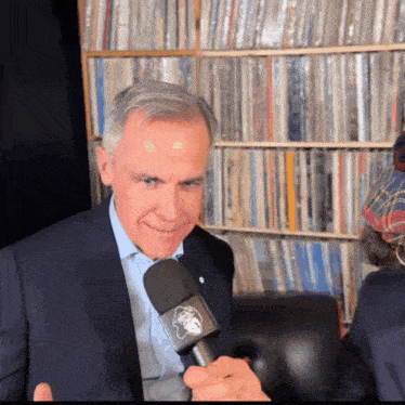 a man in a suit is holding a microphone that says texas on it