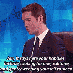 a man in a suit and tie is talking about hobbies including cooking for one solitaire and gently weeping yourself to sleep