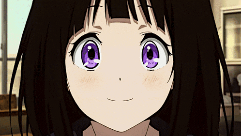 a girl with dark hair and purple eyes is smiling