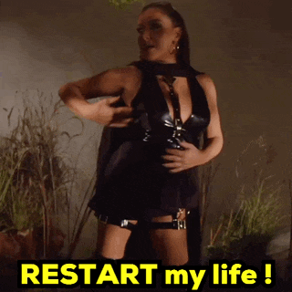 a woman in a black dress stands in front of a sign that says " restart my life "
