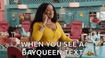a woman is talking on a cell phone in a salon .