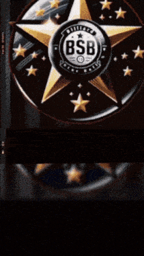 a man is standing in front of a billiard star ball emblem