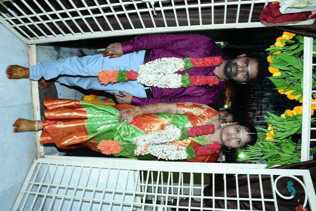 a man and a woman are posing for a picture in a doorway