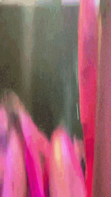 a close up of a child 's face with a pink shirt on .