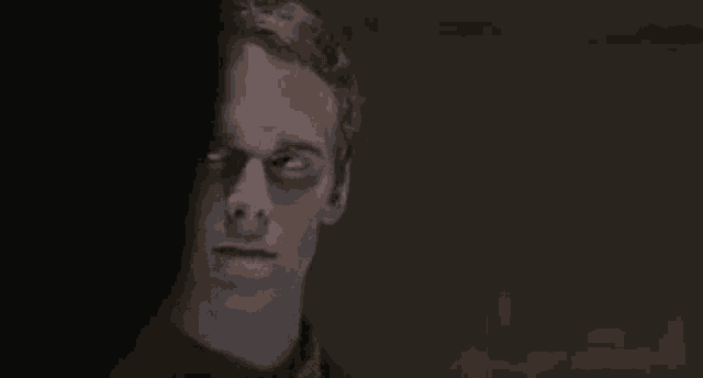 a close up of a man 's face with his eyes closed .
